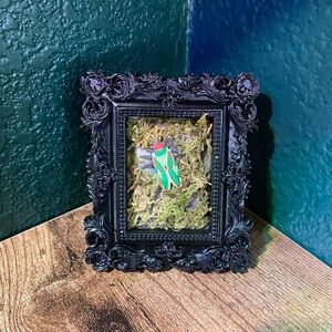Intricate Black Framed Art with Green and Red Insect
